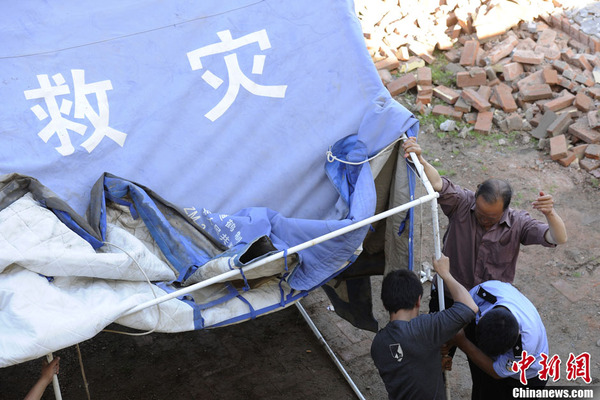 甘肃定西地震灾区村民搭建救灾帐篷