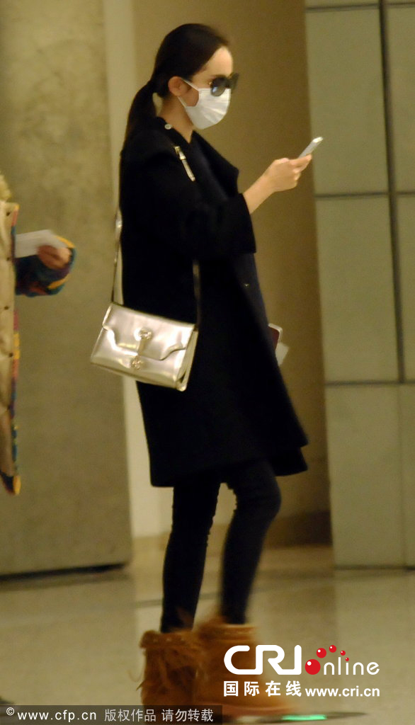 杨幂着宽松风衣藏身材孕事成迷 不时摸肚戴口