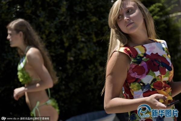 　　　　当地时间2015年7月23日，美国华盛顿，“善待动物”组织活动家身着“蔬菜比基尼”在国会山向游客分发素食热狗。图片来源：ＣＦＰ