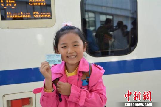 在珲春，一位小姑娘展示她手中的首列车的车票。 金乔 摄