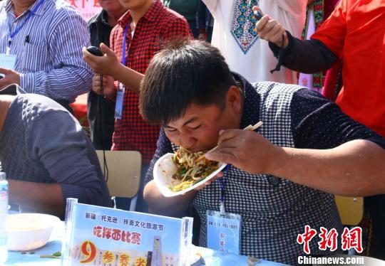 为了争夺大胃王第一，小伙子甩开膀子开始吃。　李靖海 摄