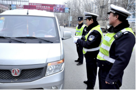 图为该局交警部门在专项行动中仔细检查过往车辆