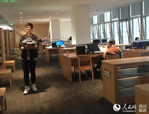 图为杨靖维将阅读后期刊整理在一起。周栩如 摄