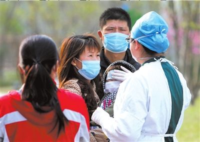 昨天，在北京地坛医院，护士用手抚摸一名儿童的前额。京华时报记者王海欣摄