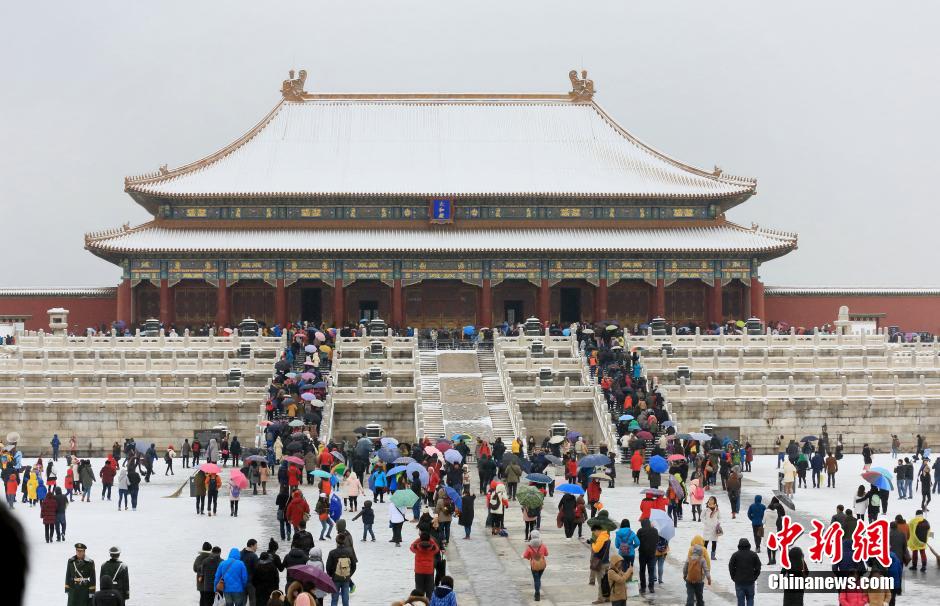 北京迎来强降雪 游人故宫排队购票赏雪景