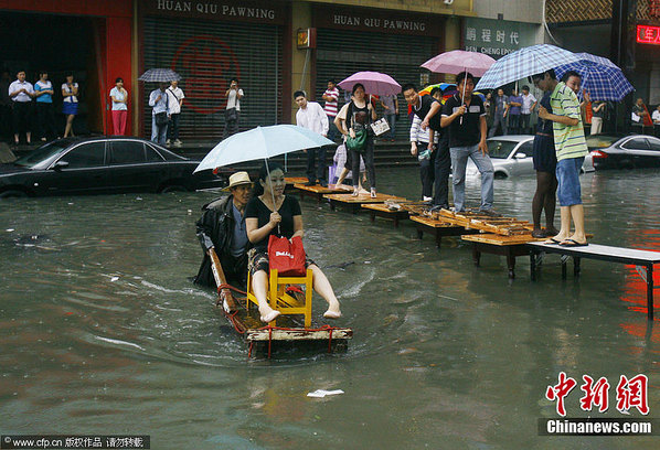 武汉暴雨致多处渍水 市民过路招数多