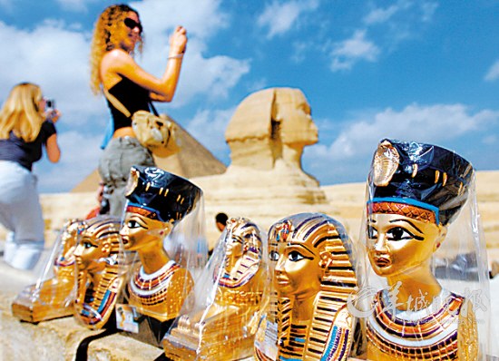 游客在埃及首都开罗郊区观看吉萨金字塔群和狮身人面像　　蔺以光 摄