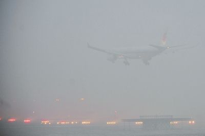 　　2月1日下午，一架客机降落在雾霾中的北京首都机场。京华时报记者陶冉摄