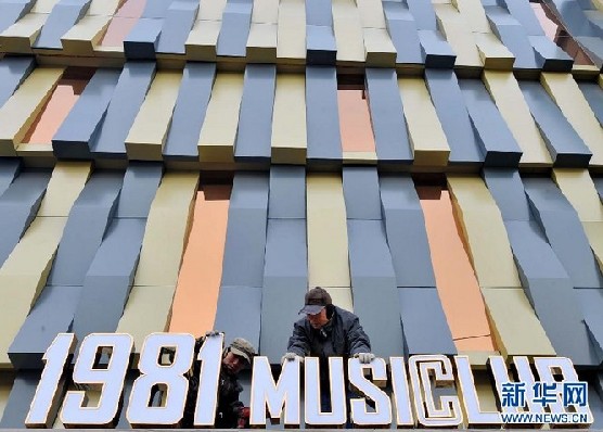 12月19日，工人在安装“1981音乐俱乐部”牌匾。