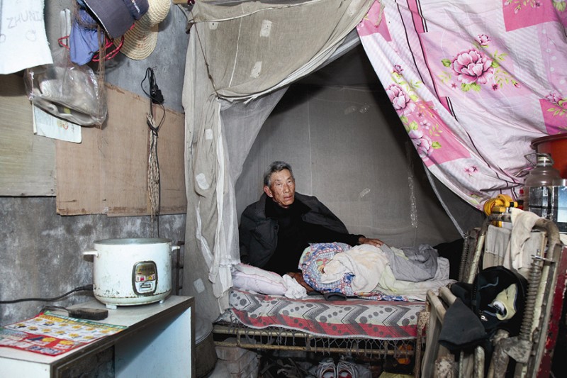 公安县斗湖堤镇曾埠头村,一位村民蜷缩在一间快要倒塌的房屋里,而其年