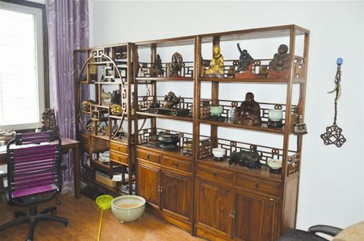 房间里,佛像,香炉,木雕,骨剑摆满了各个角落,保险柜里还藏着古董玉器